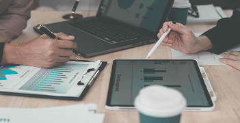 Professionals reviewing medical forms and documentation on a tablet